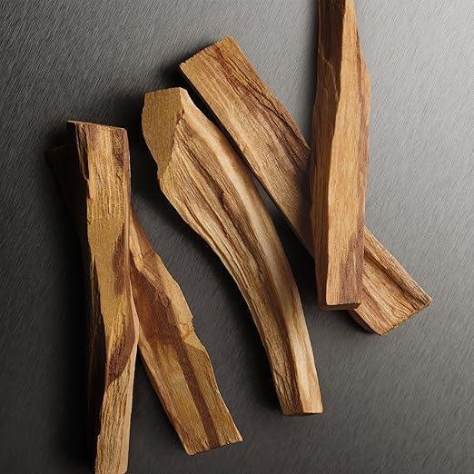 Natural sandalwood incense sticks on dark textured surface