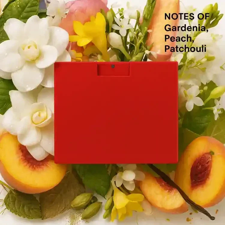 Red perfume box surrounded by gardenia, peach, and patchouli notes