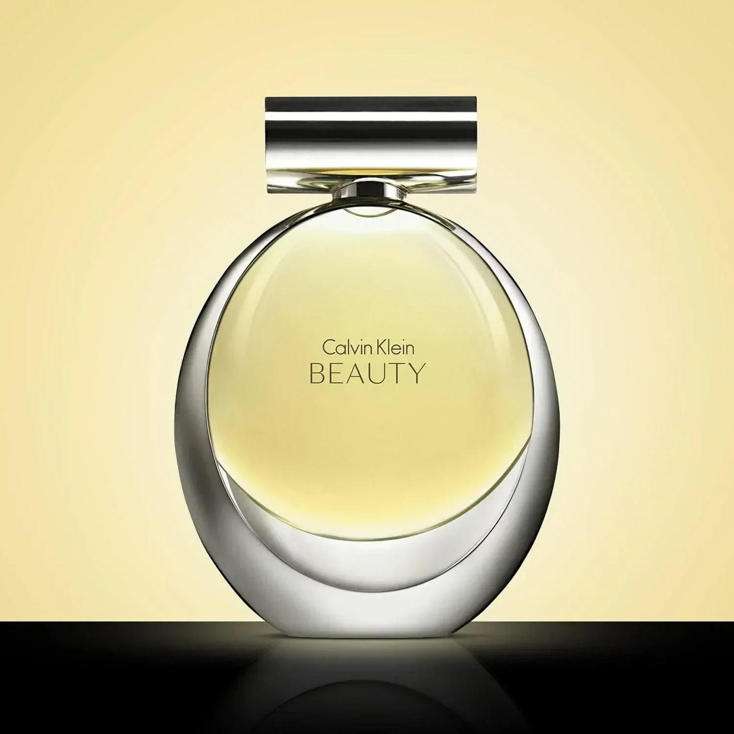 Calvin Klein Beauty Eau de Parfum fragrance bottle with silver cap on reflective surface