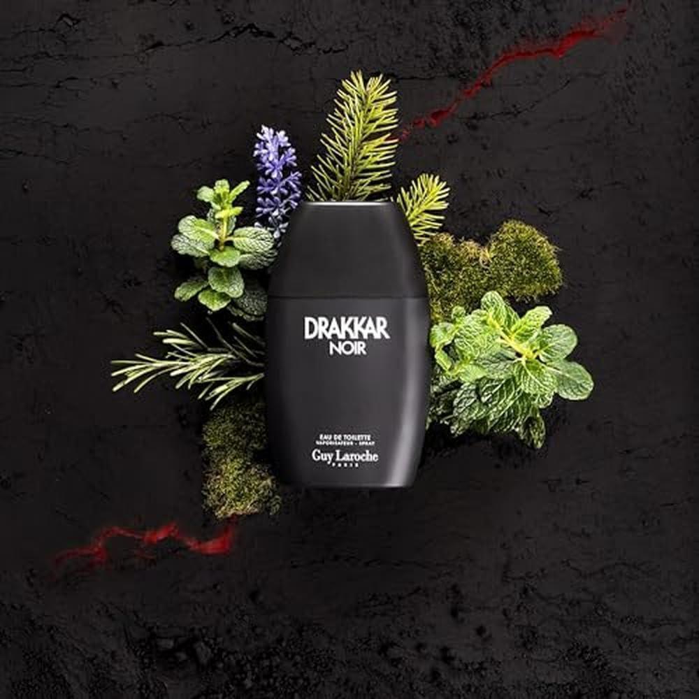 Guy Laroche Drakkar Noir Eau de Toilette fragrance bottle with greenery on dark background
