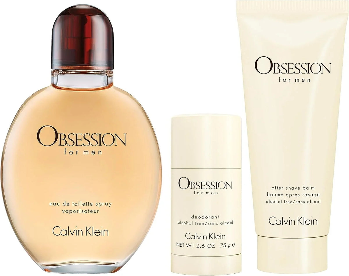 Calvin Klein Obsession for men grooming set featuring a 750 ml bottle of eau de toilette spray, a 2.6 oz deodorant stick, and a 6 cm after shave balm tube, all in a coordinated beige and amber color scheme on a white background.