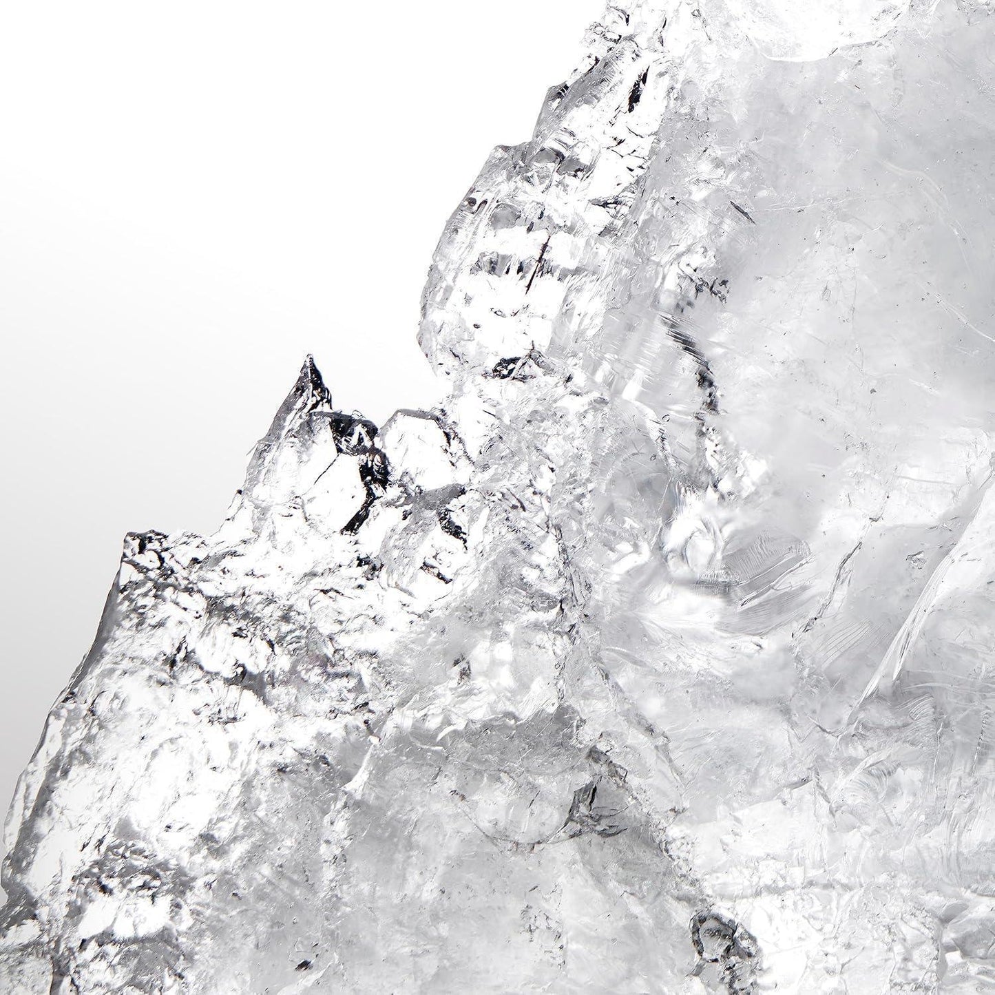 Clear textured ice formation with sharp crystalline edges against white background