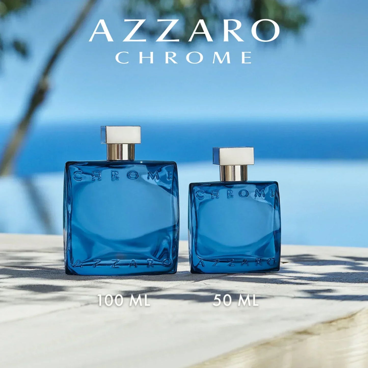 Azzaro Chrome Eau de Toilette 100ml and 50ml fragrance bottles on outdoor surface
