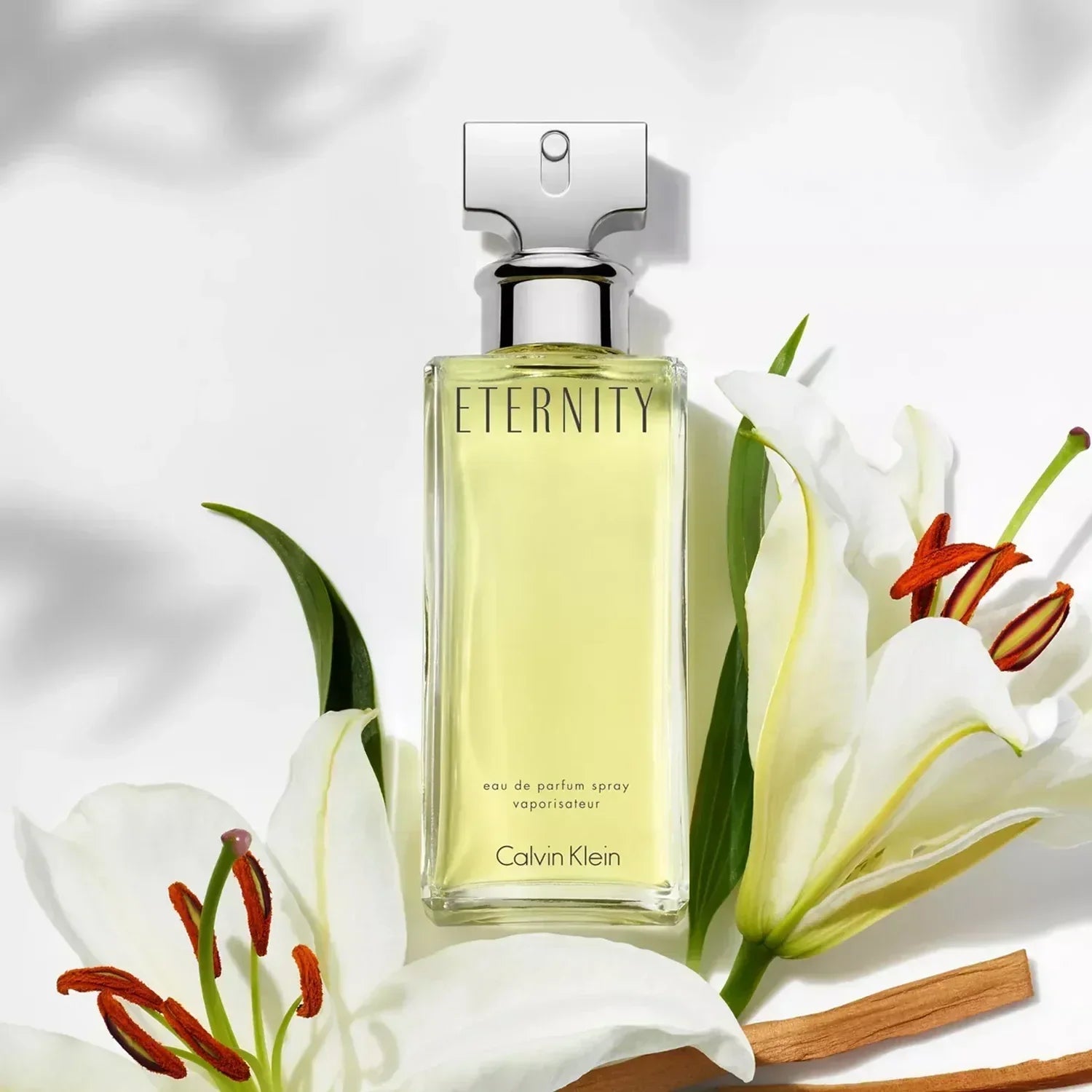 Calvin Klein Eternity eau de parfum spray bottle with white lilies and cinnamon sticks