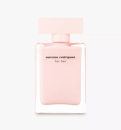 Narciso Rodriguez For Her perfume bottle in a soft pastel pink color, featuring a minimalist rectangular cap and black text on the front, set against a clean white background.
