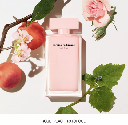 A rectangular pink perfume bottle labeled 'narciso rodriguez for her' centered on a white background, surrounded by peach fruits, pink flowers, and green leaves. Text at the bottom reads 'ROSE, PEACH, PATCHOULI'.