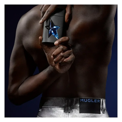 Mugler A*Men fragrance bottle held against bare torso, silver jeans with Mugler waistband