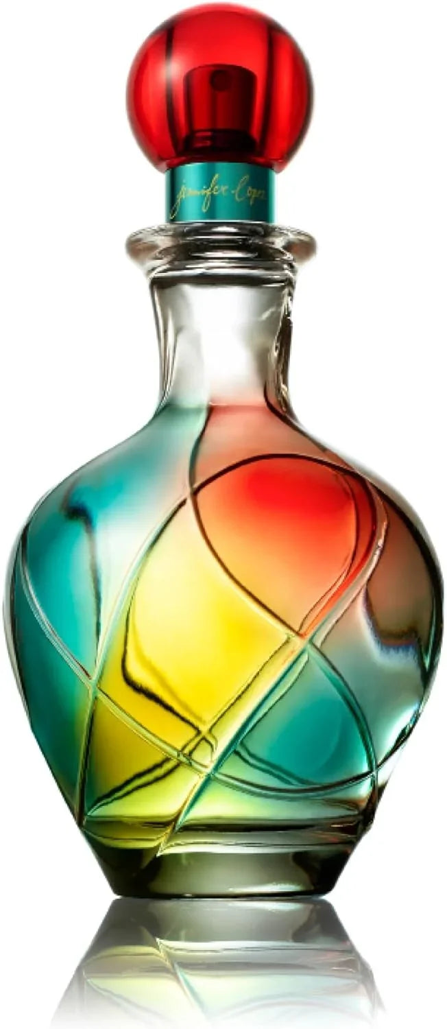 Colorful glass bottle with a red cap on a reflective surface