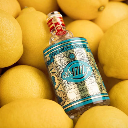 4711 Original Eau de Cologne fragrance bottle nestled among fresh lemons