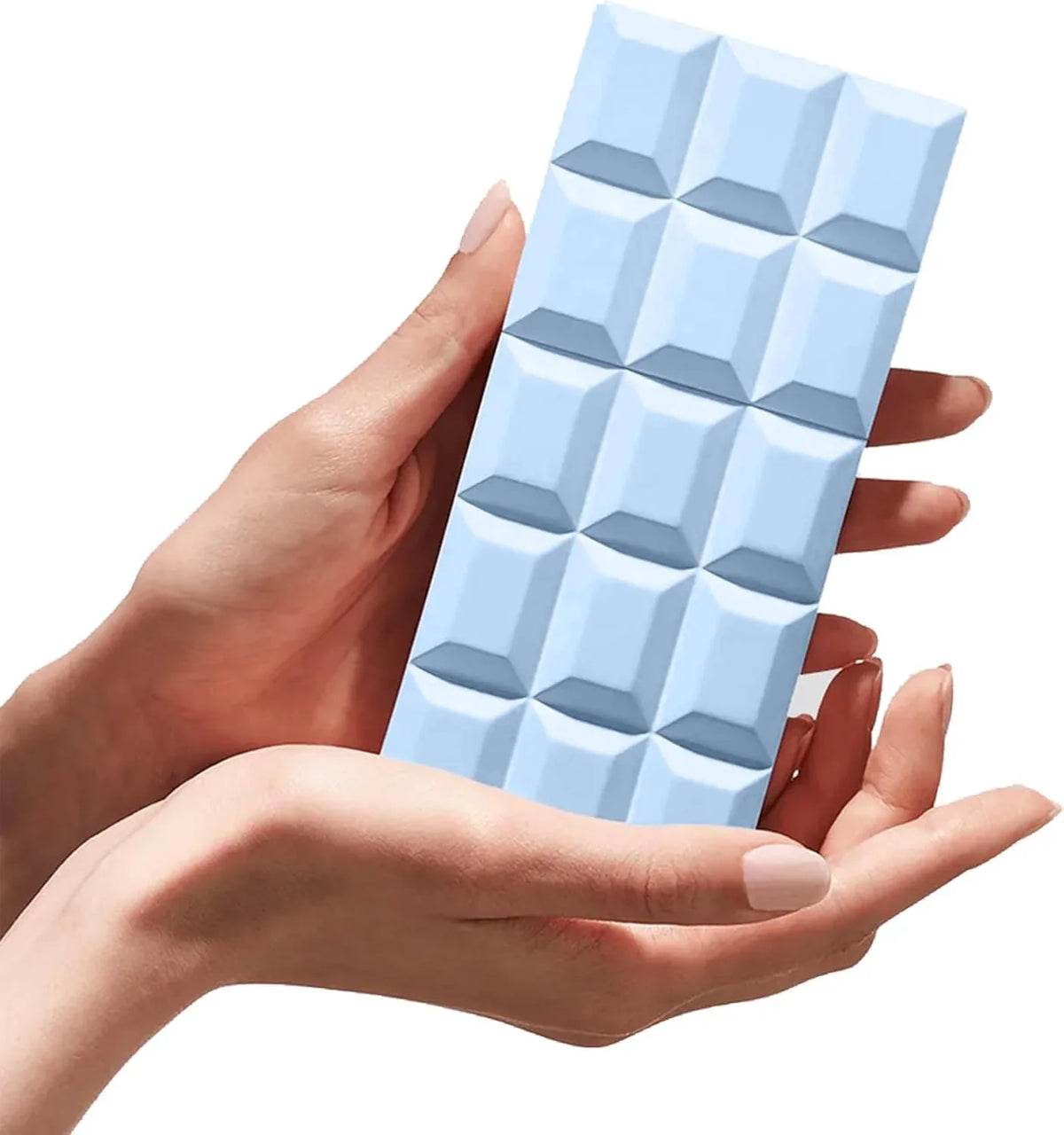 A light blue segmented bar, styled like a chocolate bar, held in two hands against a solid white background.
