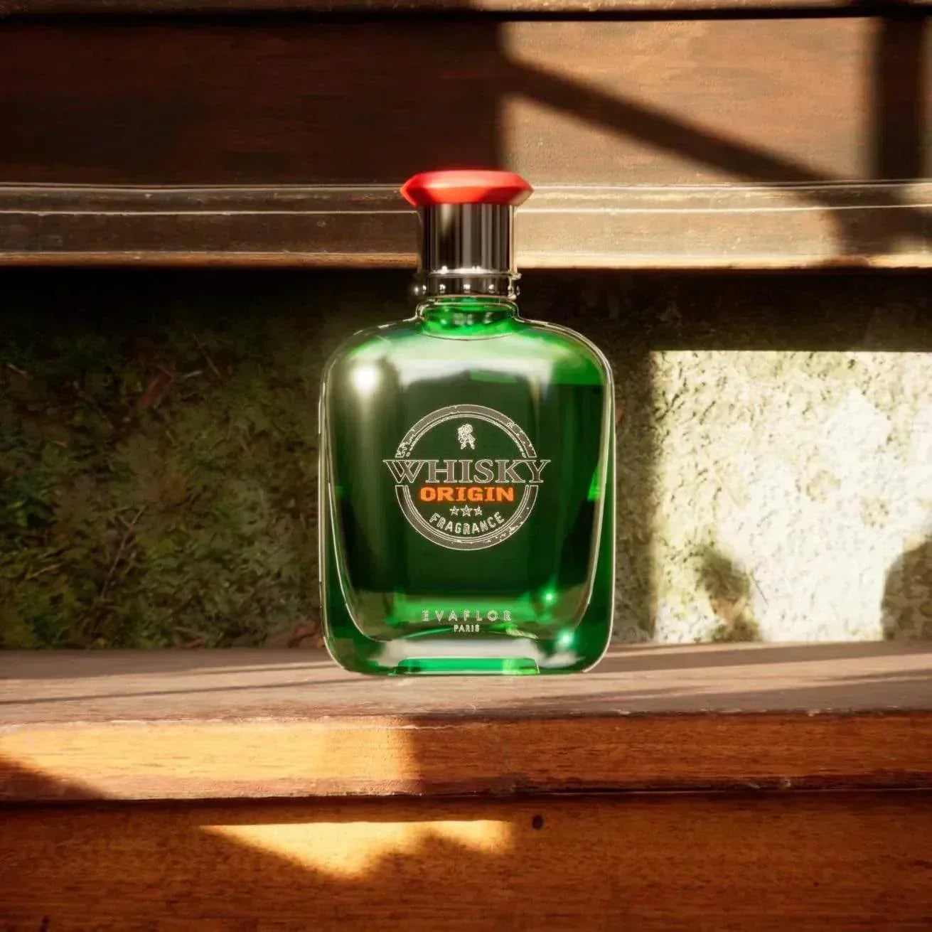 Evafior Whisky Origin fragrance bottle with green glass and red cap on wooden surface