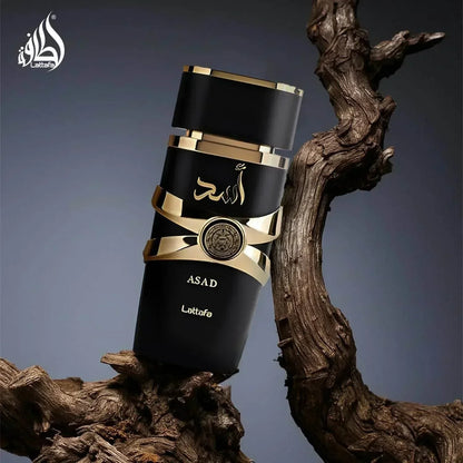 Lattafa Asad fragrance bottle with gold accents on wooden branch