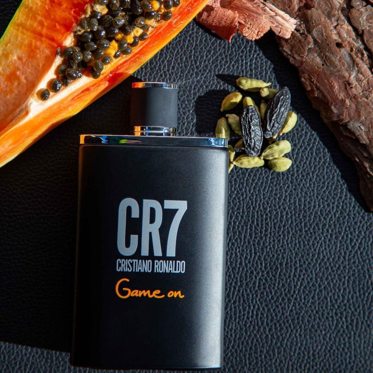 CR7 Cristiano Ronaldo Game On fragrance bottle with papaya and spices on black leather