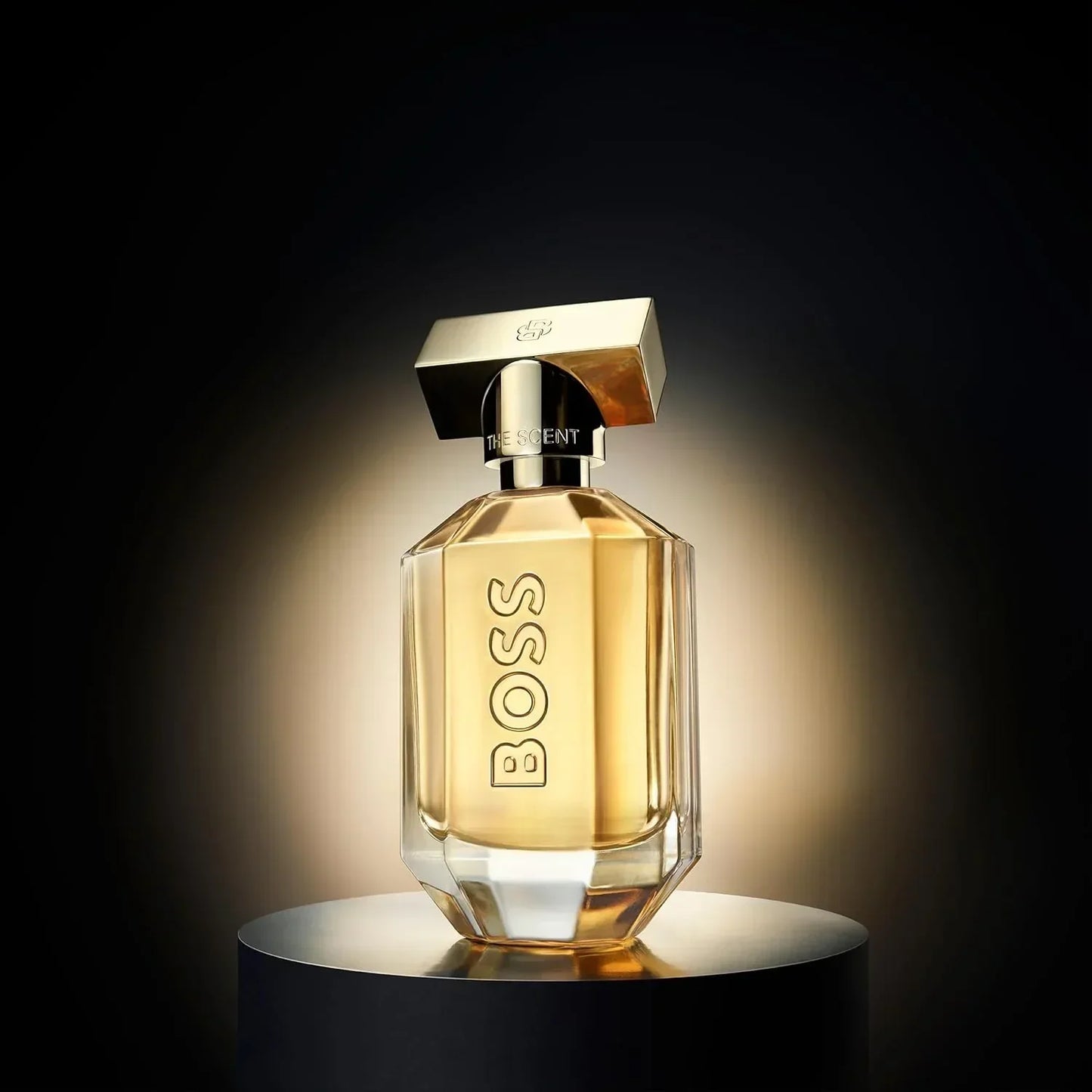 BOSS The Scent Eau de Parfum 100ml fragrance bottle on black pedestal