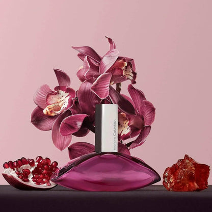 Calvin Klein Euphoria Eau de Parfum bottle with orchid, pomegranate and amber on pink background 100ml 30ml 