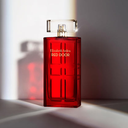 Red Elizabeth Arden perfume bottle on a light background