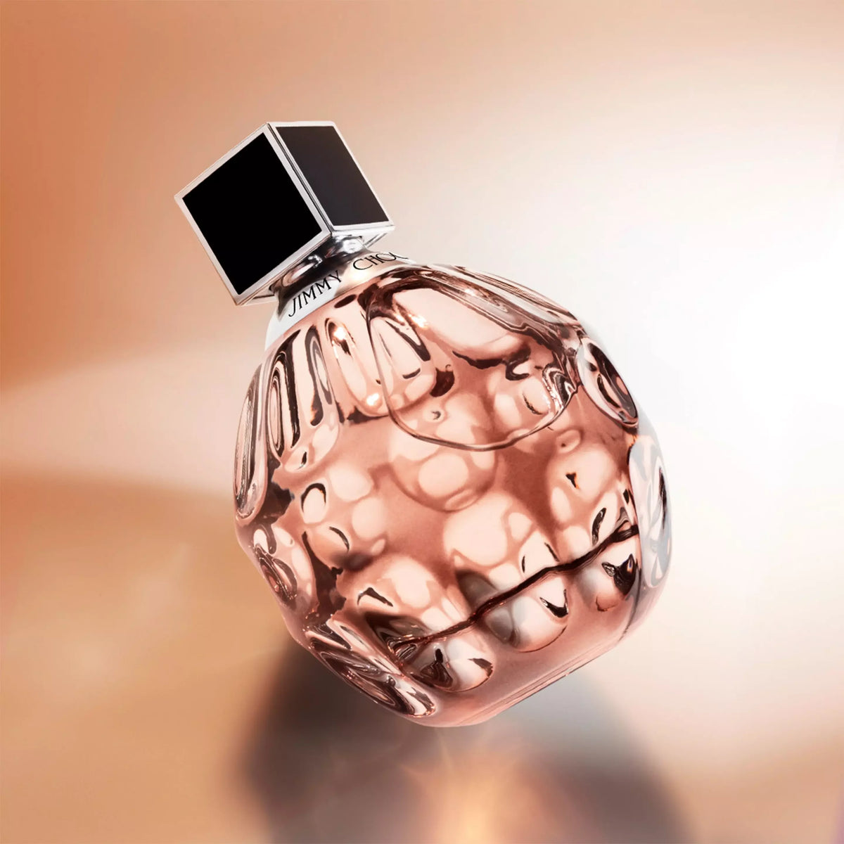 Perfume bottle with a textured surface on a gradient background