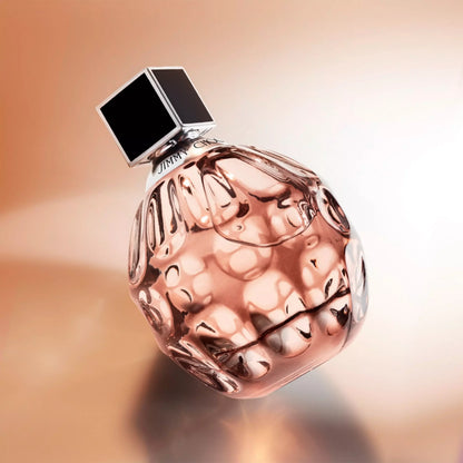 Perfume bottle with a textured surface on a gradient background