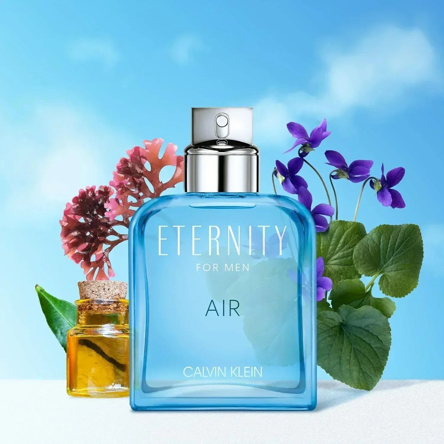 Calvin Klein Eternity for Men Air fragrance bottle with purple flowers and coral against blue sky