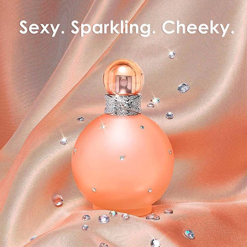 Paris Hilton Sexy Sparkling Cheeky Eau de Parfum bottle with crystals on peach fabric