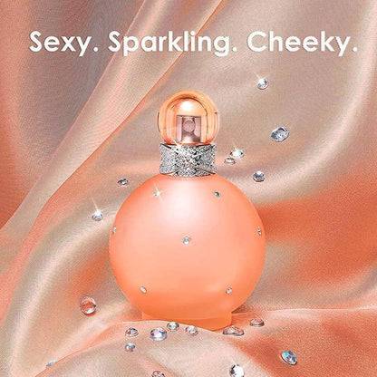 Paris Hilton Sexy Sparkling Cheeky Eau de Parfum bottle with crystals on peach fabric