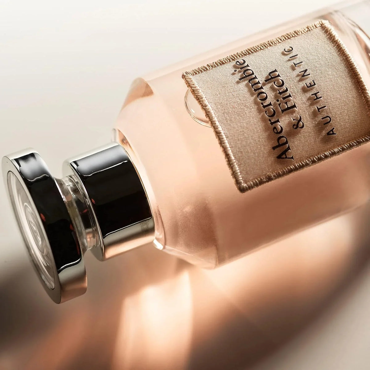 Perfume bottle with Abercrombie & Fitch label on a light background