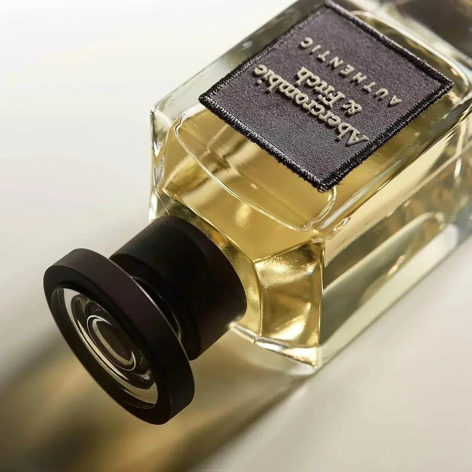 Abercrombie & Fitch Authentic fragrance bottle with black cap and gold liquid
