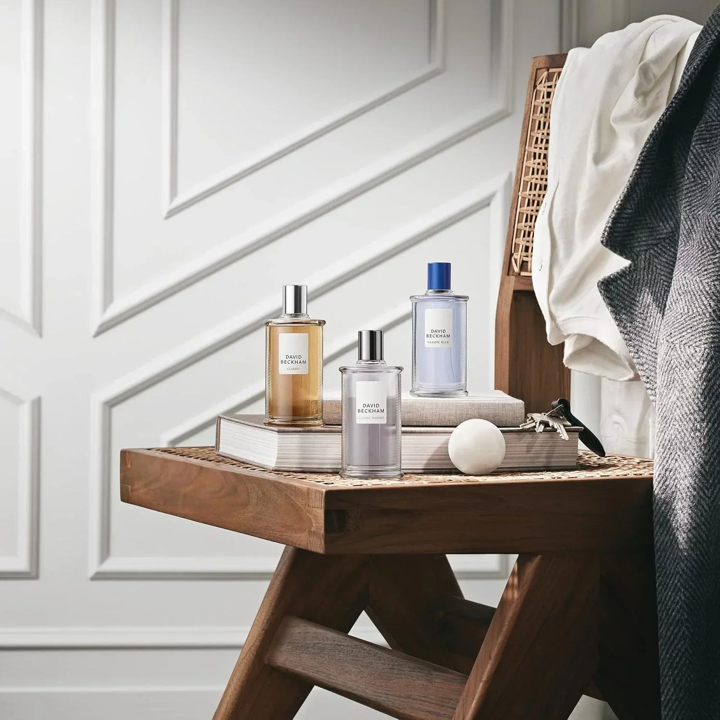 David Beckham Classic, Classic Homme, Classic Blue fragrance bottles on wooden stool with books