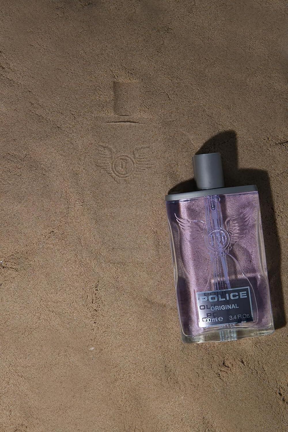 Police Original Eau de Toilette 100ml fragrance bottle on sandy surface