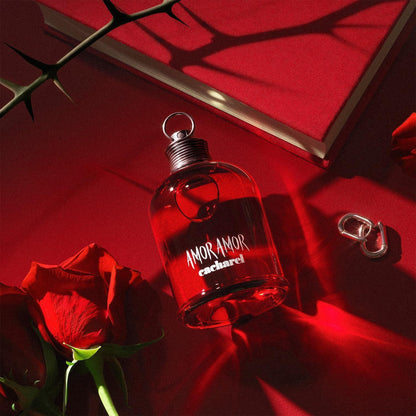 Cacharel Amor Amor Eau de Toilette fragrance bottle with red rose and thorns