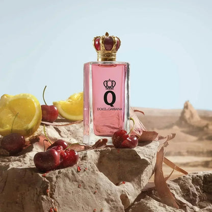 Dolce & Gabbana Q Eau de Parfum bottle with cherries and lemon on rock