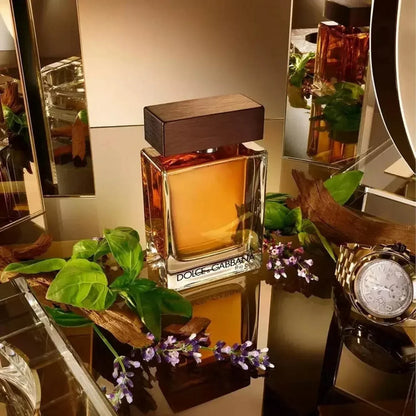 Dolce & Gabbana The One Eau de Parfum bottle with retail box, green leaves and purple flowers