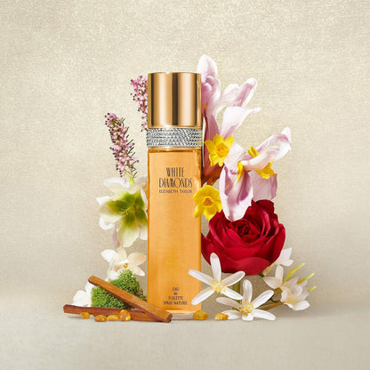 Perfume bottle with decorative flowers on a beige background