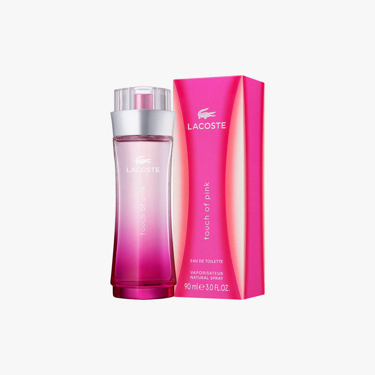 Lacoste Touch of Pink Eau de Toilette bottle in pink gradient glass next to its bright pink packaging box, on a light gray background. 90ml
