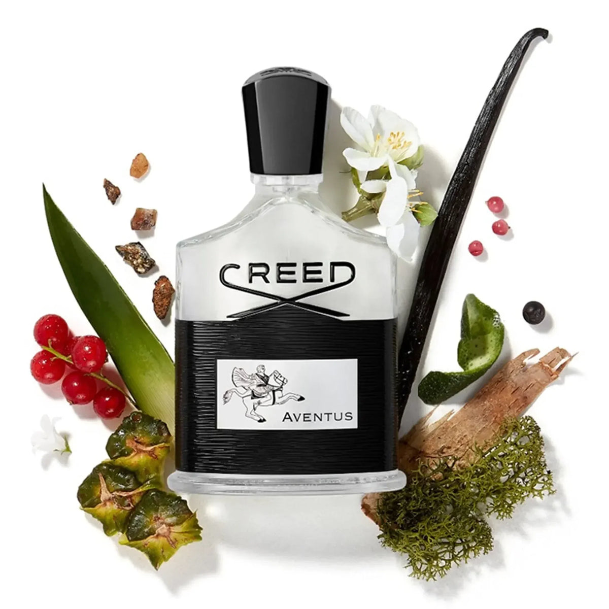 Creed Aventus perfume bottle surrounded by flowers, leaves, and fruits on a white background