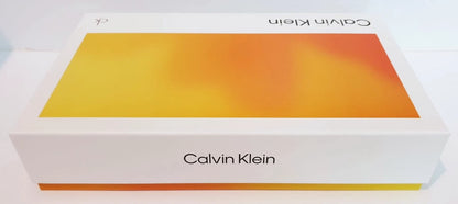 Calvin Klein product box with a white base and a large yellow-to-orange gradient panel on the top, photographed on a clean white background.