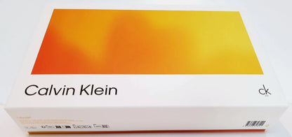 Calvin Klein product box with a white base and a large orange-to-yellow gradient panel on top, shown on a plain light background.